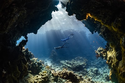 a scuba diver swims through an underwater cave